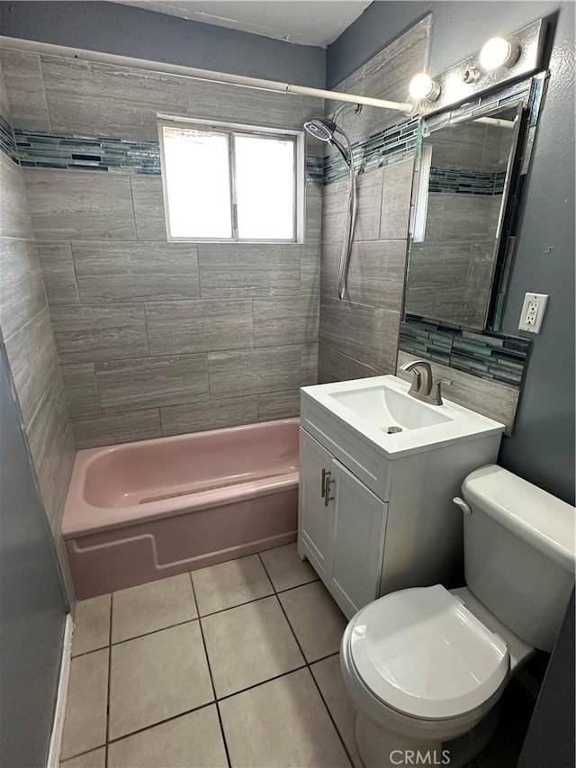 full bathroom featuring tiled shower / bath, vanity, toilet, and tile patterned flooring