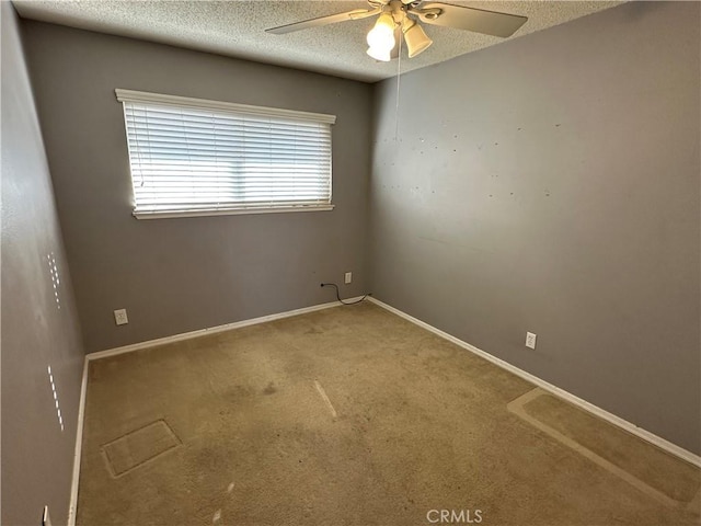 unfurnished room with ceiling fan, a textured ceiling, and carpet