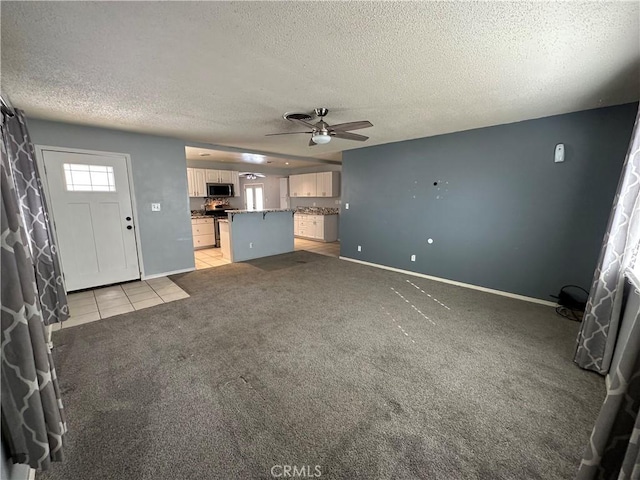 unfurnished living room featuring ceiling fan, light carpet, and a textured ceiling