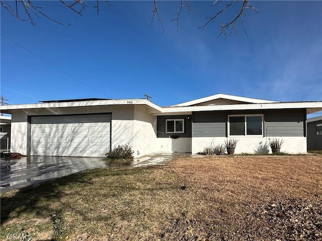 exterior space featuring a garage and a front lawn