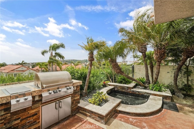 view of patio featuring an outdoor kitchen and a grill