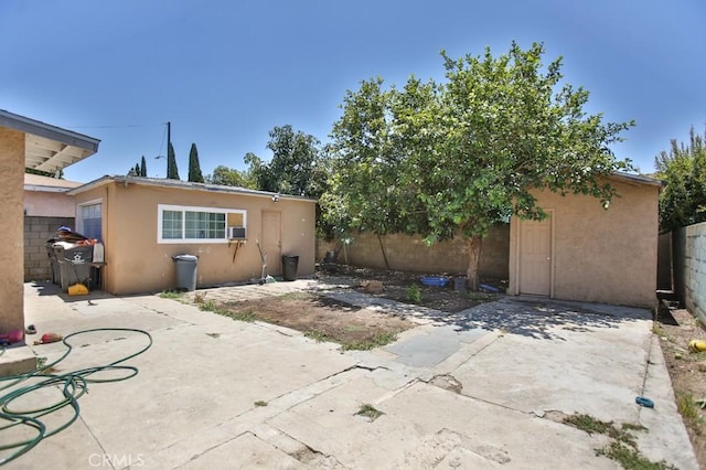 view of patio / terrace featuring a fenced backyard, cooling unit, and an outbuilding