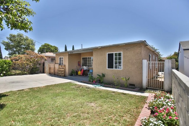 view of front of property featuring a gate, fence, and stucco siding