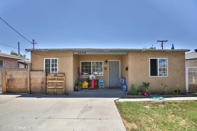 view of front of home featuring fence and stucco siding