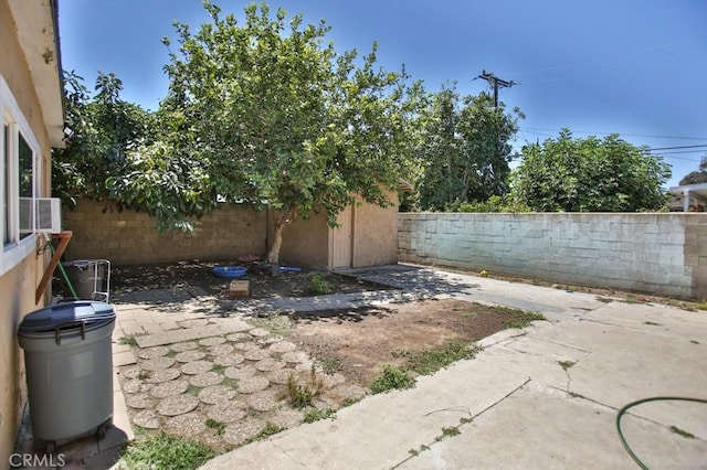 view of patio / terrace featuring an outbuilding, a fenced backyard, and a storage shed