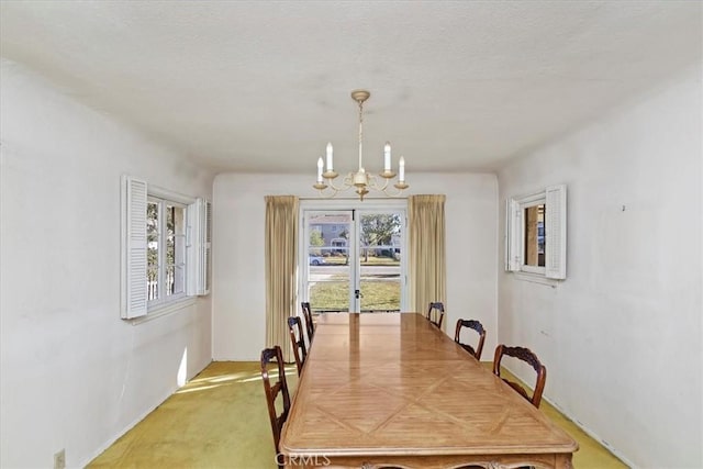 dining space featuring plenty of natural light and an inviting chandelier