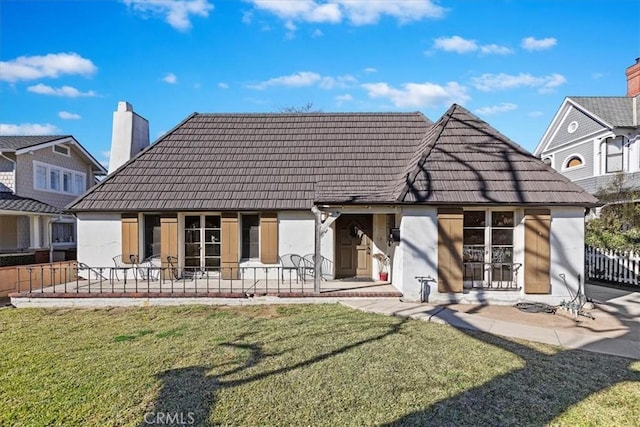 back of property featuring a yard and a patio