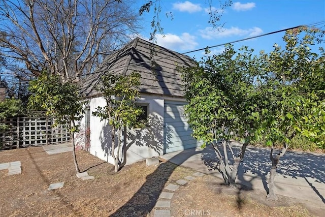 view of side of home with an outbuilding