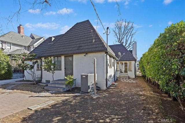 rear view of house featuring central AC