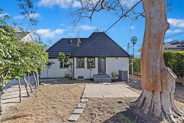 back of house featuring a patio area and central air condition unit