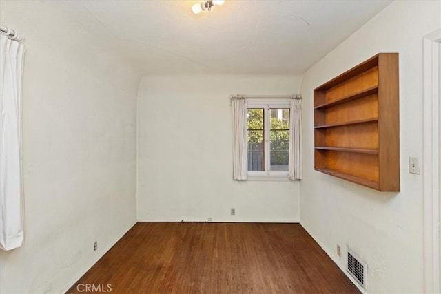 spare room featuring dark hardwood / wood-style flooring