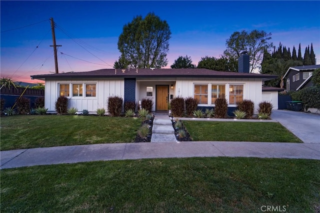 single story home with a yard and a garage