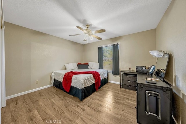 bedroom with ceiling fan and light wood-type flooring