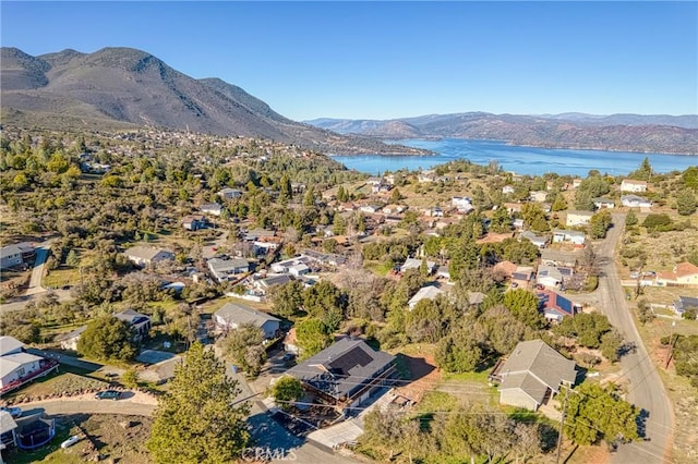 drone / aerial view featuring a water and mountain view