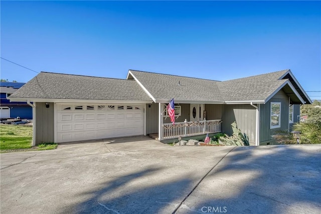 single story home with a porch and a garage