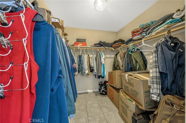 walk in closet featuring light tile patterned flooring