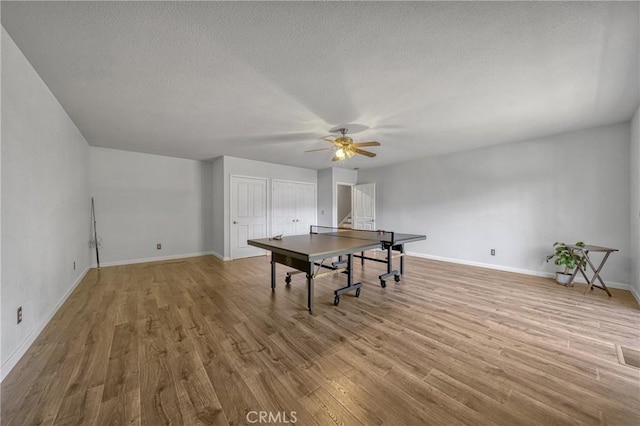 recreation room featuring ceiling fan and light wood-type flooring