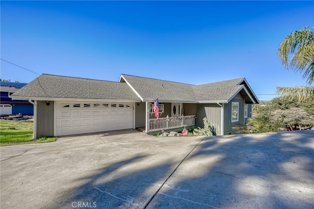 ranch-style home featuring a garage and covered porch