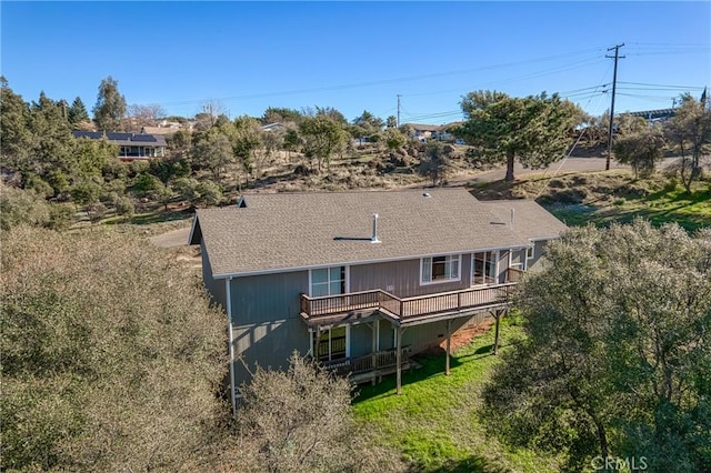 rear view of property with a yard and a deck