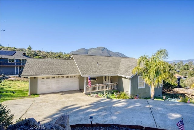 ranch-style home with a garage and a mountain view