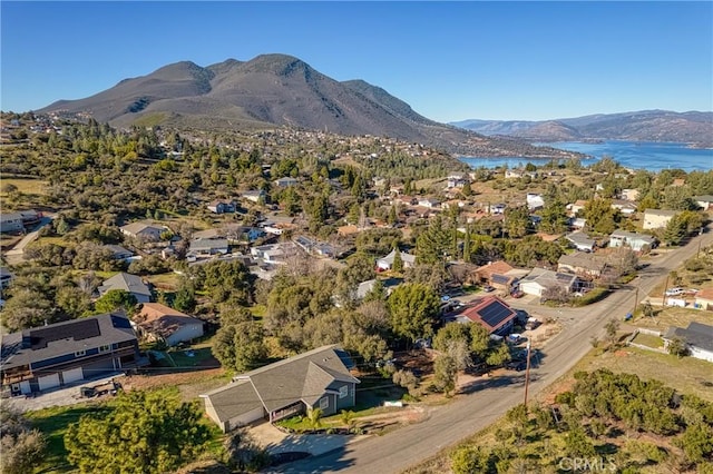 drone / aerial view with a water and mountain view