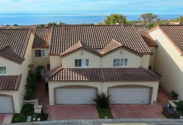 view of front of property with a water view and a garage