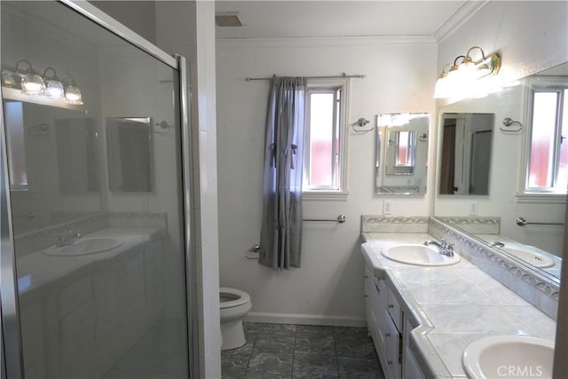 bathroom with vanity, crown molding, a shower with shower door, and toilet