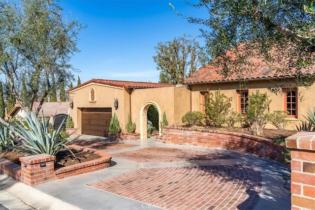 mediterranean / spanish house featuring a garage