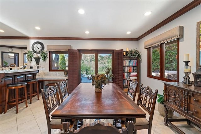 dining area with crown molding and light tile patterned floors