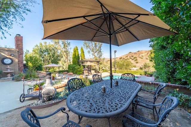 view of patio / terrace featuring a mountain view