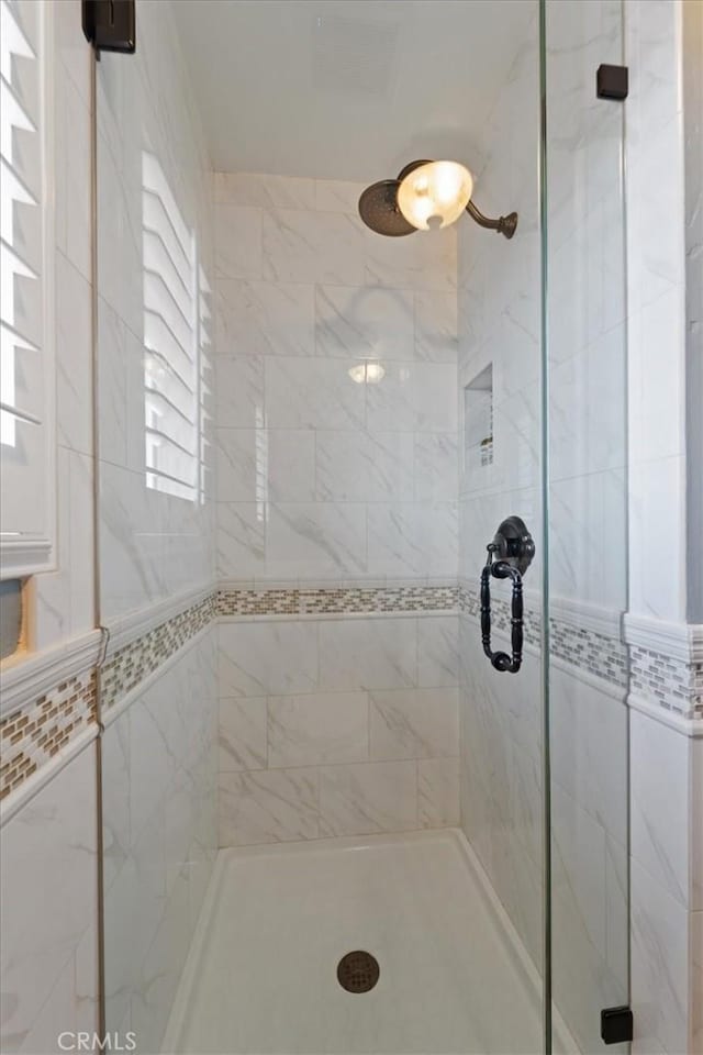 bathroom featuring an enclosed shower