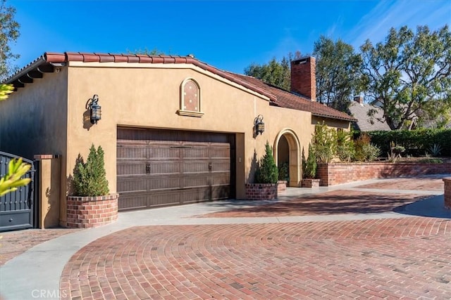 mediterranean / spanish-style home with a garage