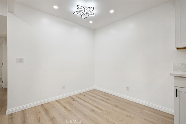 spare room with light hardwood / wood-style flooring