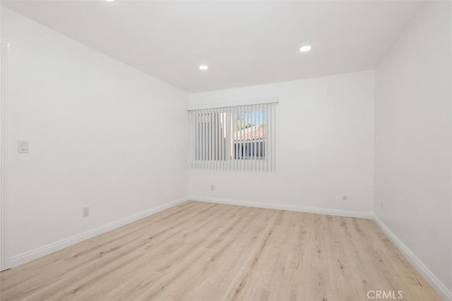 spare room with light hardwood / wood-style flooring