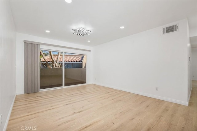 unfurnished room with light hardwood / wood-style flooring