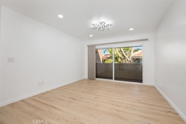 empty room with light hardwood / wood-style flooring