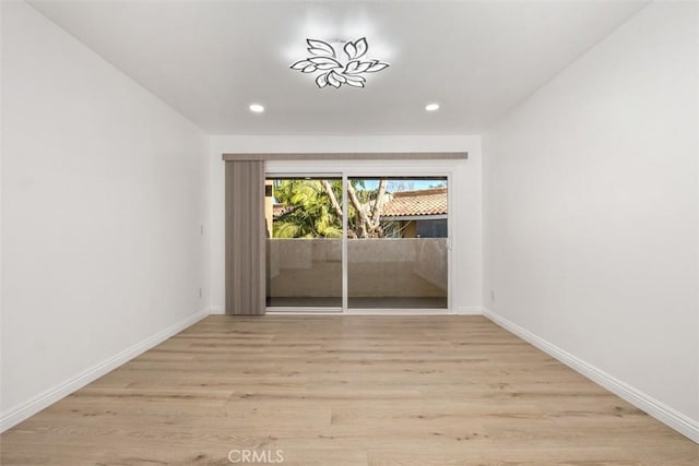 empty room with light hardwood / wood-style flooring