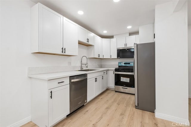 kitchen featuring white cabinetry, appliances with stainless steel finishes, and sink