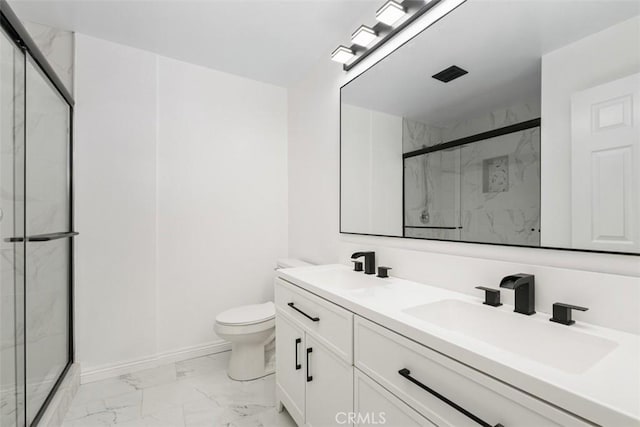 bathroom featuring a shower with door, vanity, and toilet