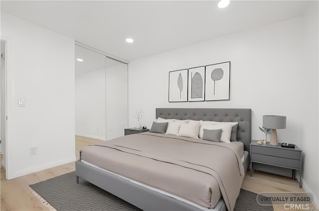 bedroom with a closet and light wood-type flooring