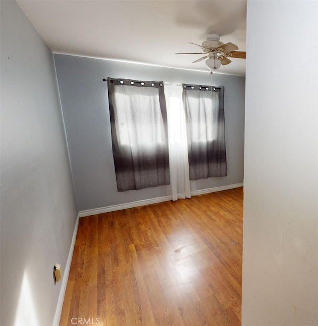 spare room with hardwood / wood-style floors and ceiling fan