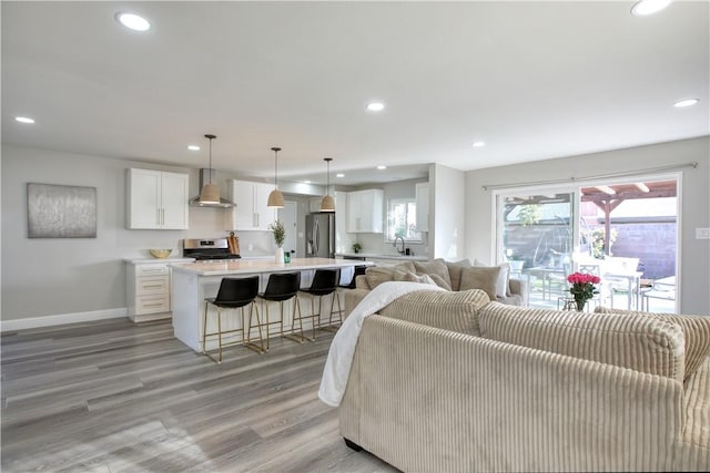 living room with sink and light wood-type flooring