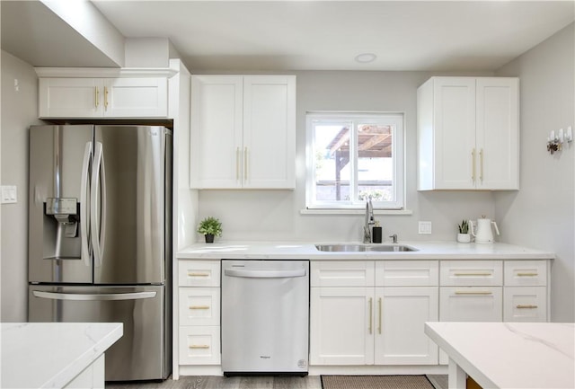 kitchen featuring white cabinetry, sink, and appliances with stainless steel finishes