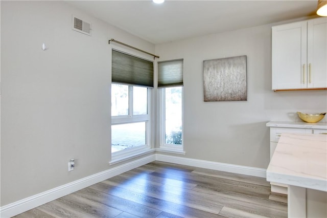 unfurnished dining area featuring light hardwood / wood-style floors