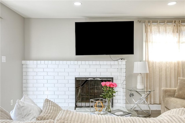 living room featuring a brick fireplace