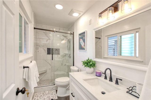 bathroom with an enclosed shower, vanity, and toilet