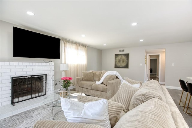 living room with a brick fireplace