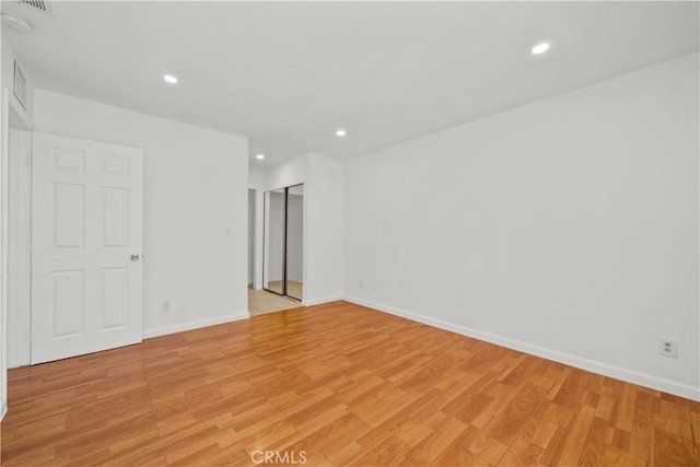 spare room with light wood-type flooring