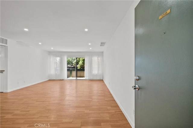 unfurnished room with light wood-type flooring