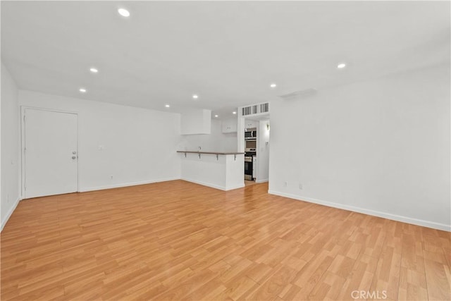 unfurnished living room with light hardwood / wood-style floors